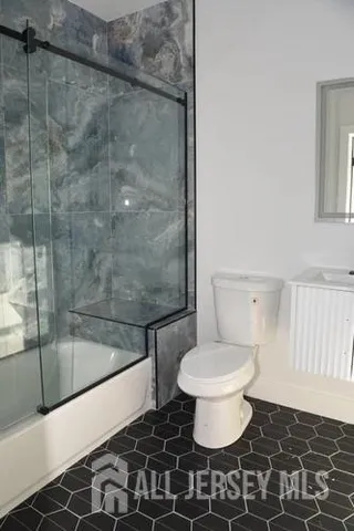 a bathroom with a toilet and a mirror