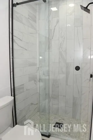 a bathroom with a toilet and a mirror