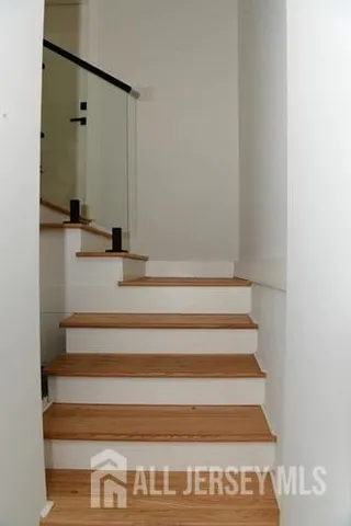 a view of kitchen and a room with wooden floor