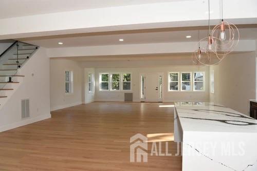 28 Plymouth Place Edison, NJ 08837 - Photo 19 of 33 a view of kitchen and a room with wooden floor