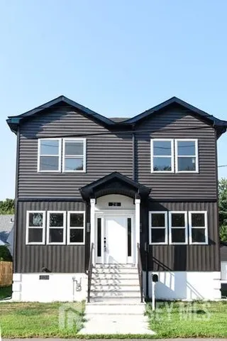 a front view of a house with a yard
