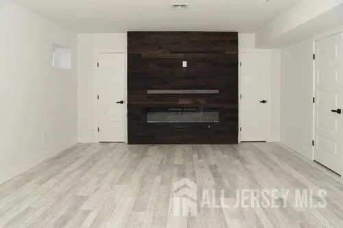 a view of room with a bed and a dresser