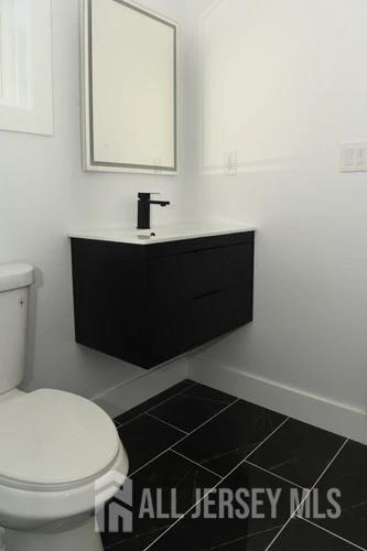 28 Plymouth Place Edison, NJ 08837 - Photo 24 of 33 a bathroom with a sink and a toilet
