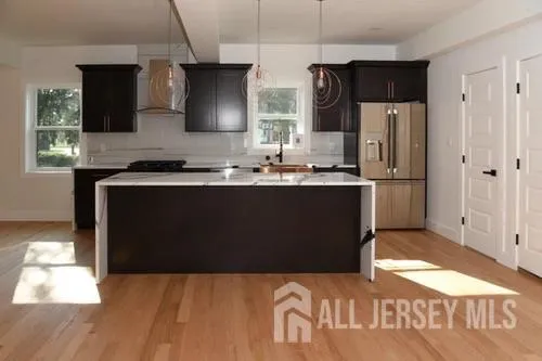 a kitchen with cabinets and wooden floor