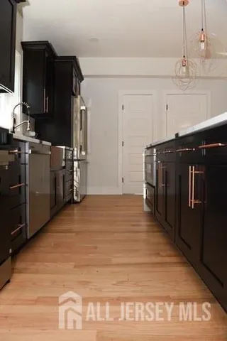 a kitchen with a sink a stove and cabinets