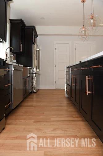 28 Plymouth Place Edison, NJ 08837 - Photo 8 of 33 a kitchen with cabinets and wooden floor