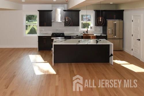 28 Plymouth Place Edison, NJ 08837 - Photo 10 of 33 a kitchen with stainless steel appliances granite countertop a sink and a refrigerator
