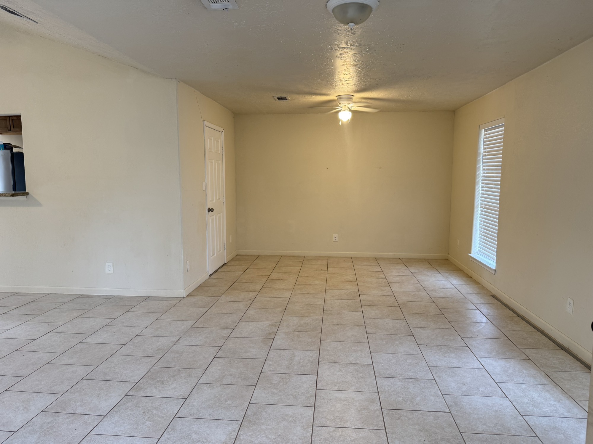 6214 Nowlin Drive Baytown, TX 77521 - Photo 4 of 12 wooden floor in an empty room with a window