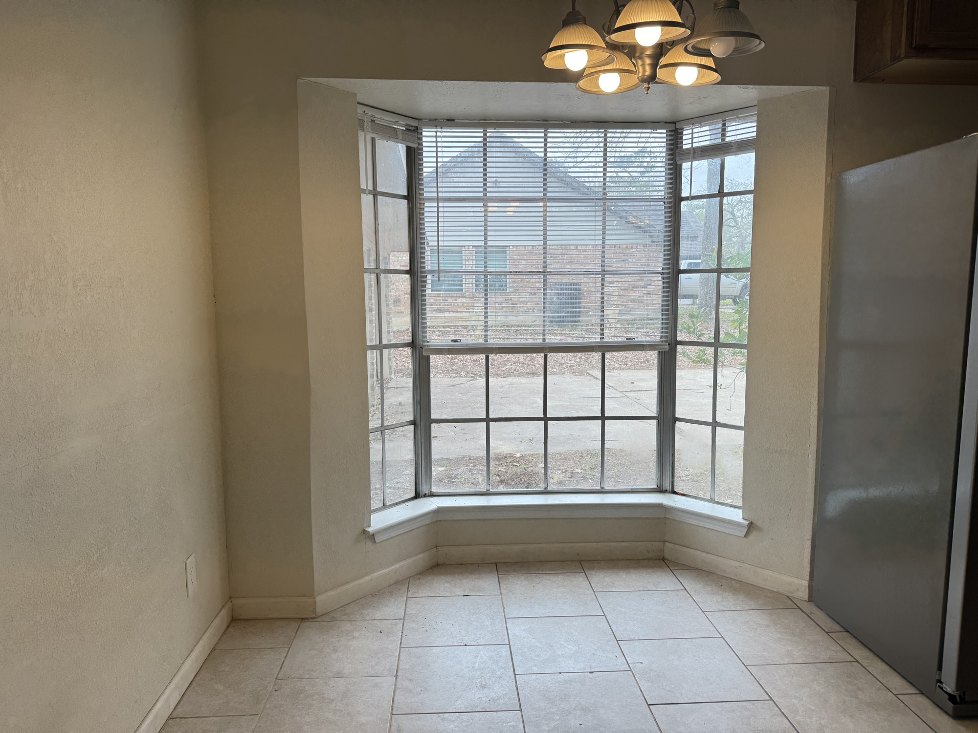 6214 Nowlin Drive Baytown, TX 77521 - Photo 7 of 12 a view of an empty room with a window