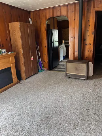 a view of a room with wooden floor and furniture