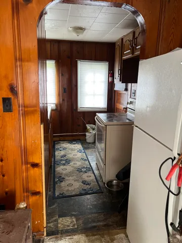 a kitchen with a refrigerator and a stove