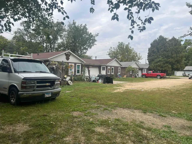 a view of front a house with a garden and pathway