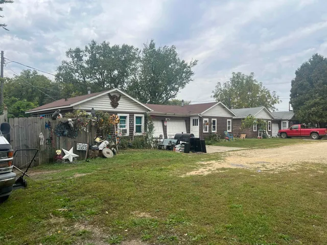a view of a house with garden and sitting area
