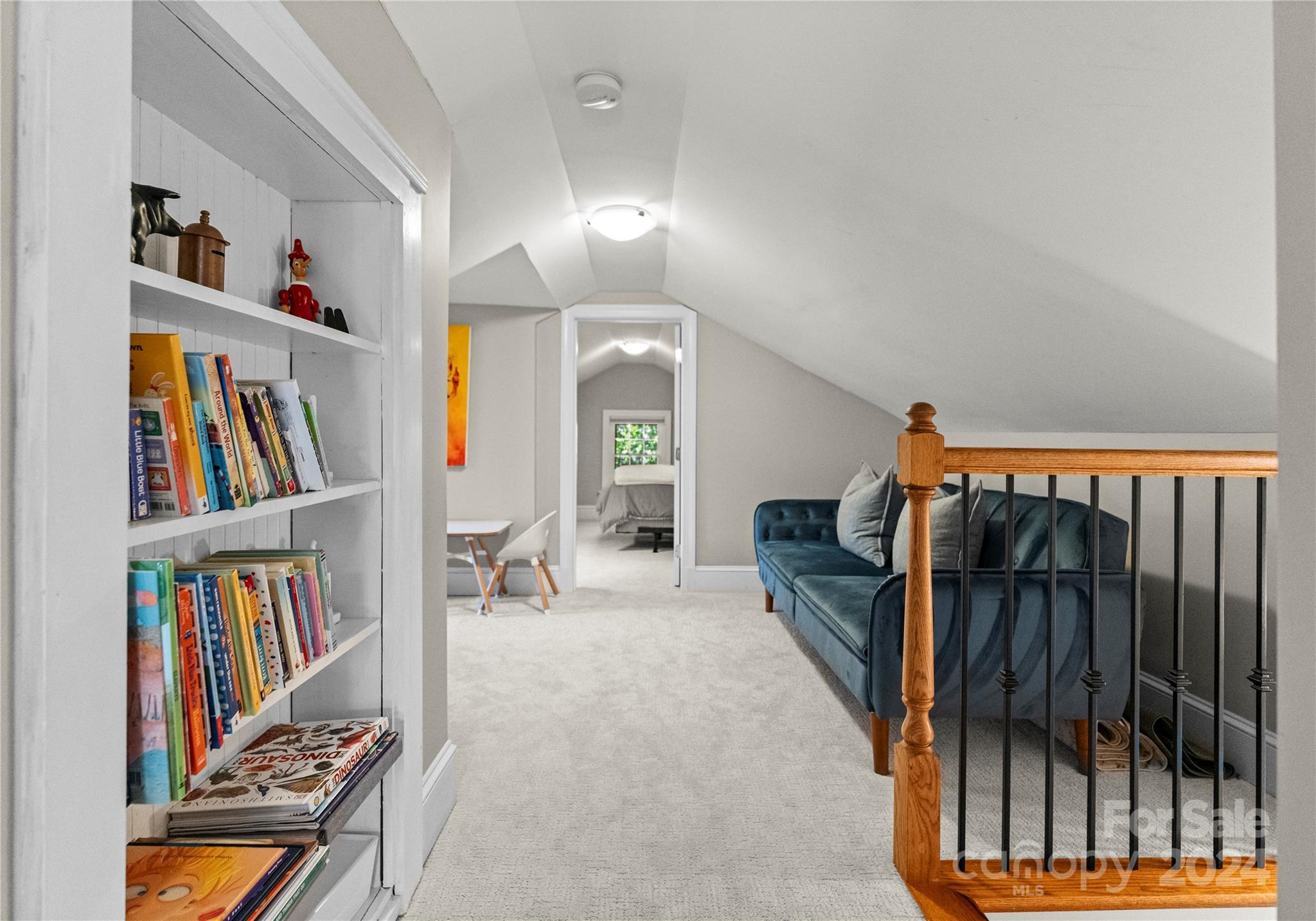 1108 Sedgefield Road Charlotte, NC 28209 - Photo 17 of 24 a living room with lots of furniture and a book shelf
