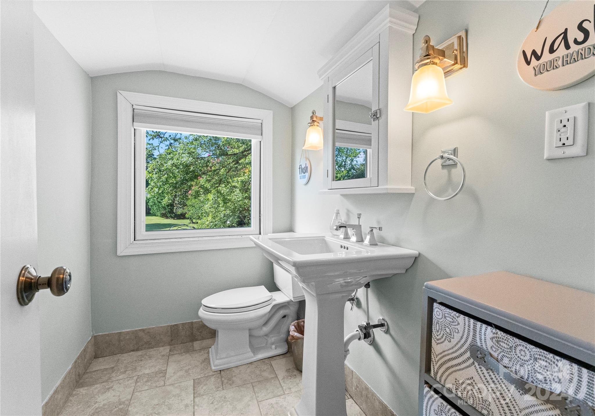 1108 Sedgefield Road Charlotte, NC 28209 - Photo 20 of 24 a bathroom with a sink toilet and a mirror