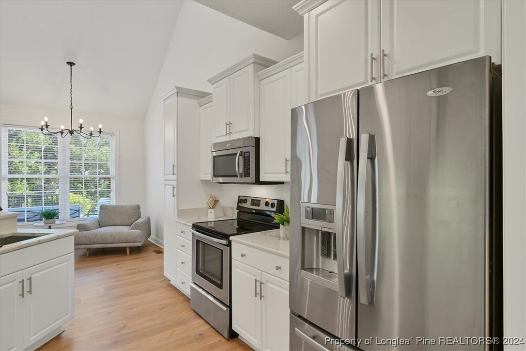 512 Maple Leaf Way Lumberton, NC 28358 - Photo 12 of 50 a kitchen with stainless steel appliances a refrigerator sink and stove