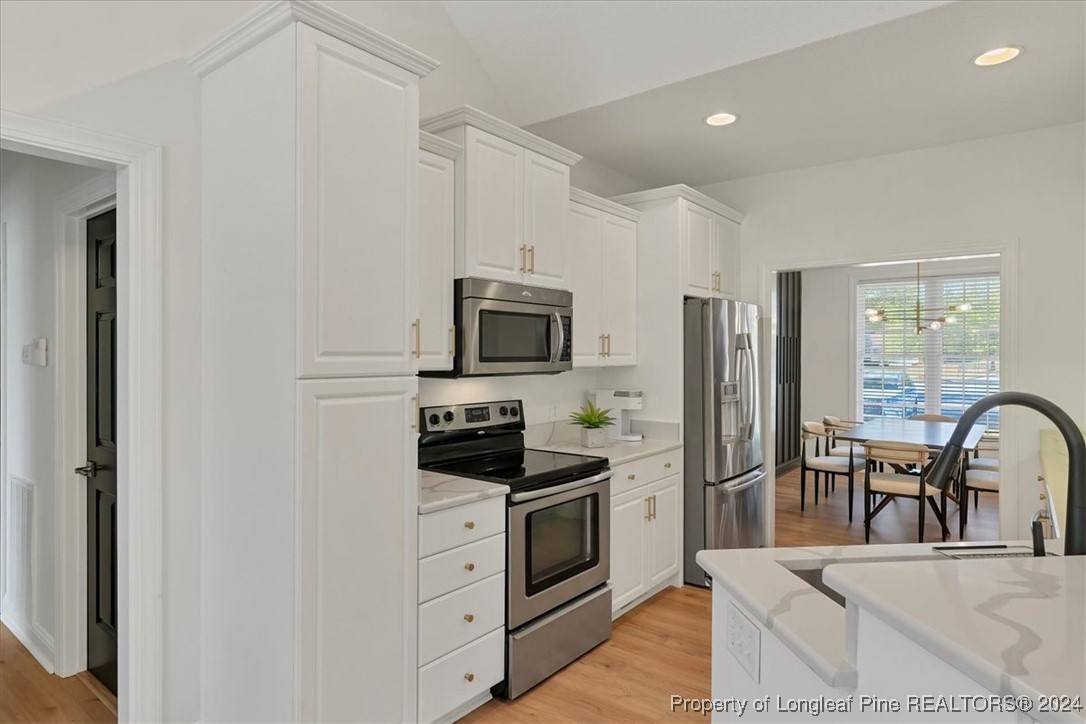 512 Maple Leaf Way Lumberton, NC 28358 - Photo 17 of 50 a kitchen with stainless steel appliances a stove microwave and a refrigerator
