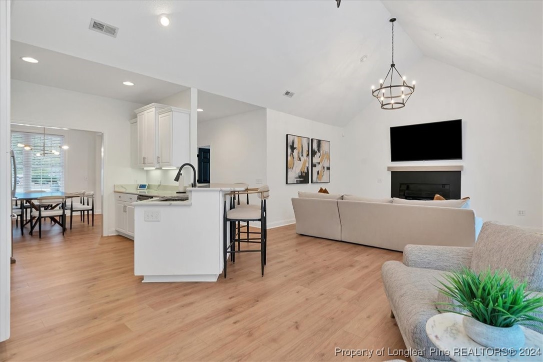 512 Maple Leaf Way Lumberton, NC 28358 - Photo 18 of 50 a living room with furniture a dining table and a fireplace