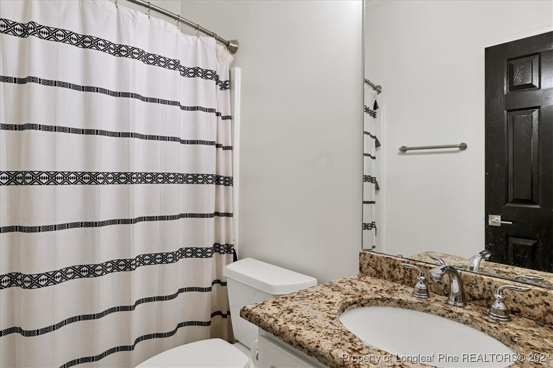 512 Maple Leaf Way Lumberton, NC 28358 - Photo 28 of 50 a bathroom with a granite countertop sink and a mirror