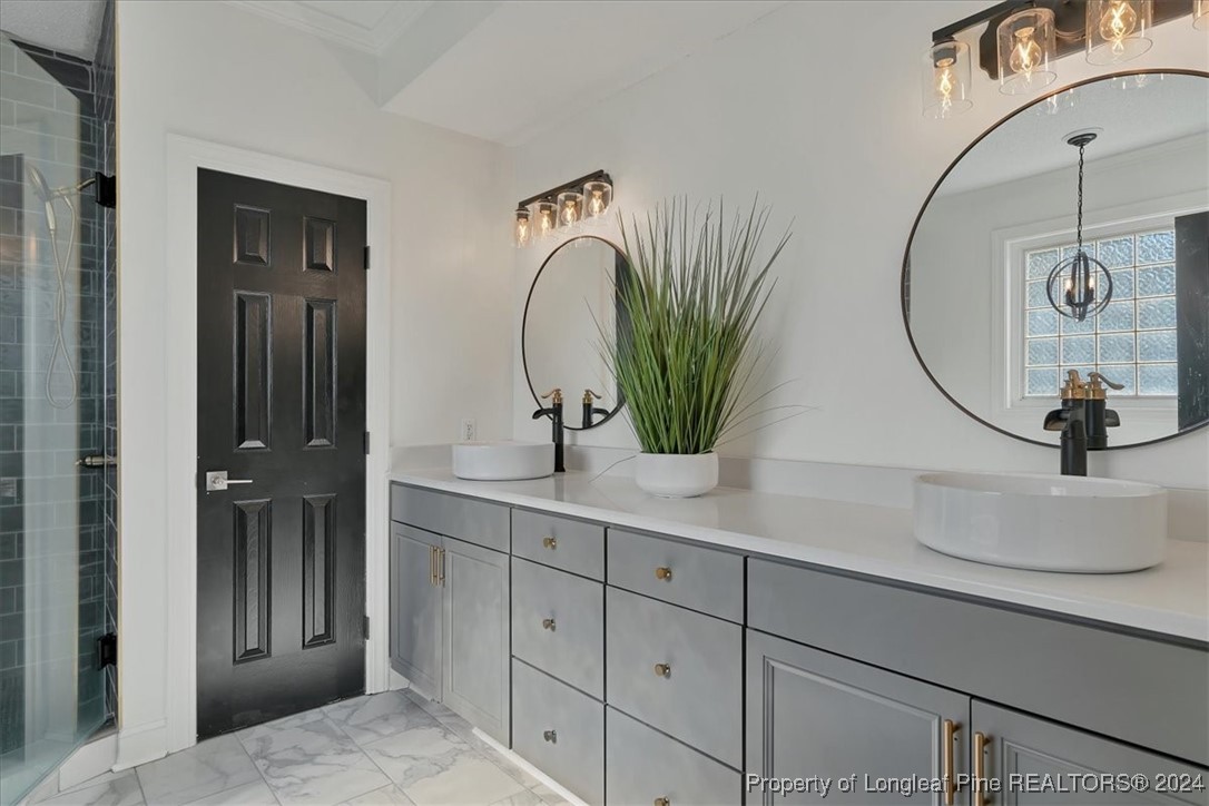 512 Maple Leaf Way Lumberton, NC 28358 - Photo 36 of 50 a bathroom with a double vanity sink and a mirror