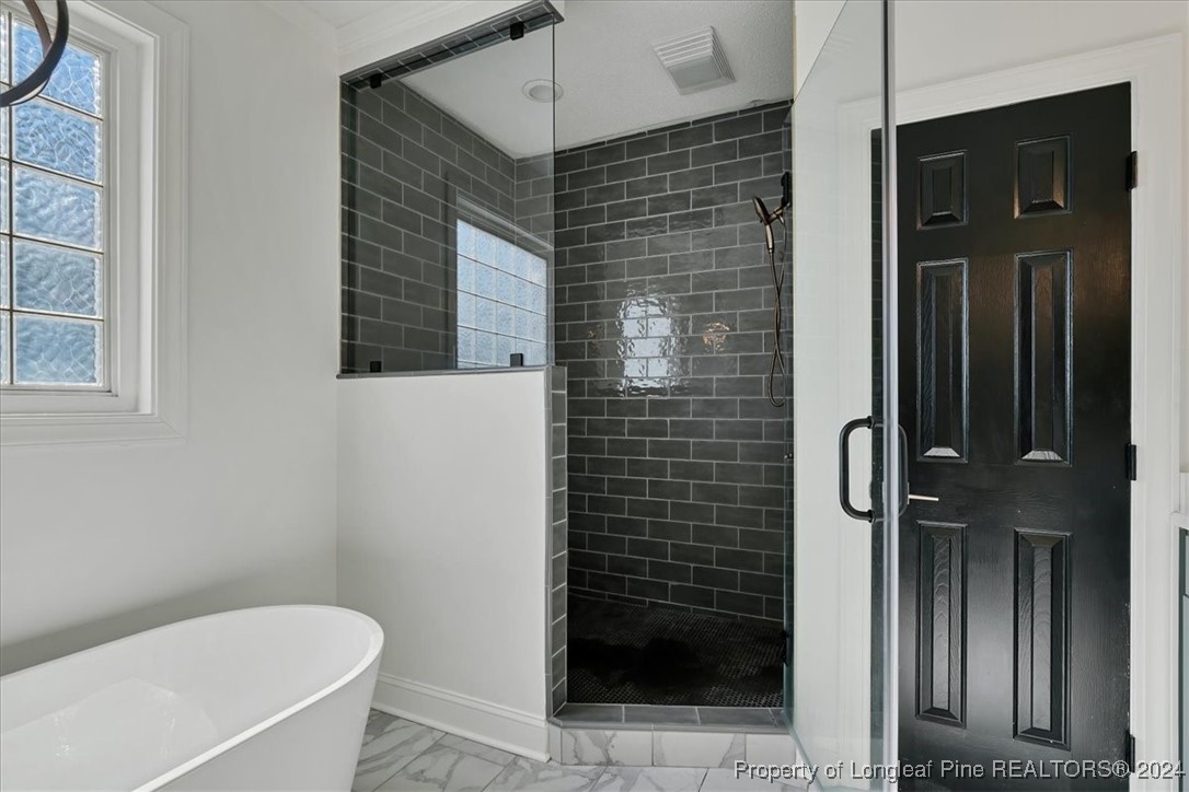512 Maple Leaf Way Lumberton, NC 28358 - Photo 37 of 50 a bathroom with a bathtub and shower