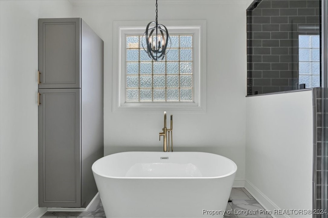 512 Maple Leaf Way Lumberton, NC 28358 - Photo 39 of 50 a white bath tub sitting in a bathroom