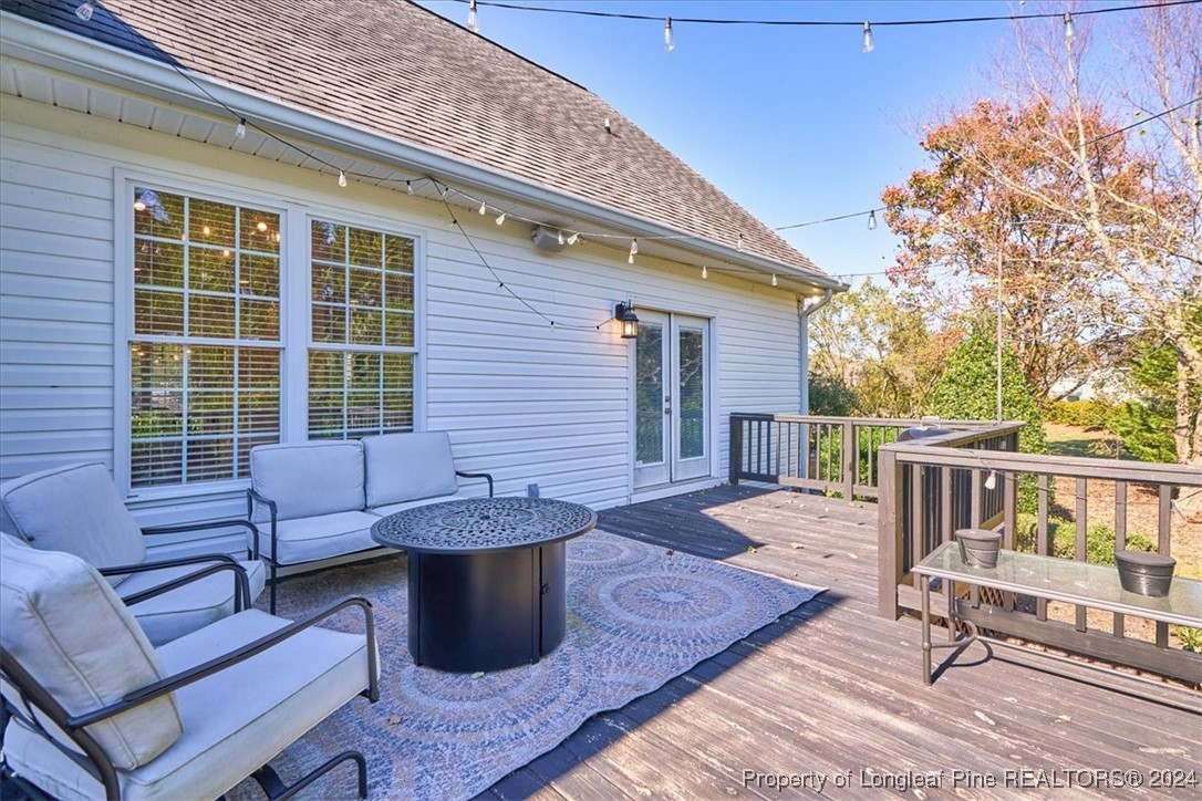 512 Maple Leaf Way Lumberton, NC 28358 - Photo 46 of 50 a view of a patio with couches chairs and wooden floor