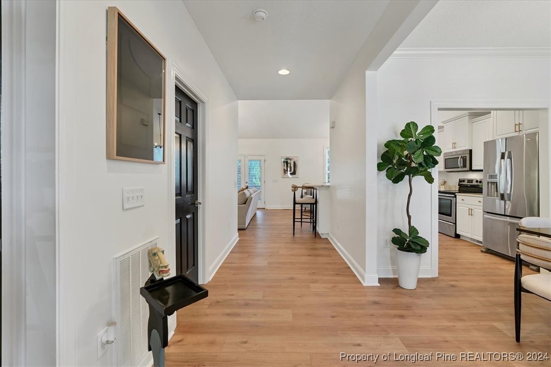 512 Maple Leaf Way Lumberton, NC 28358 - Photo 5 of 50 a view of a hallway with wooden floor and a potted plant