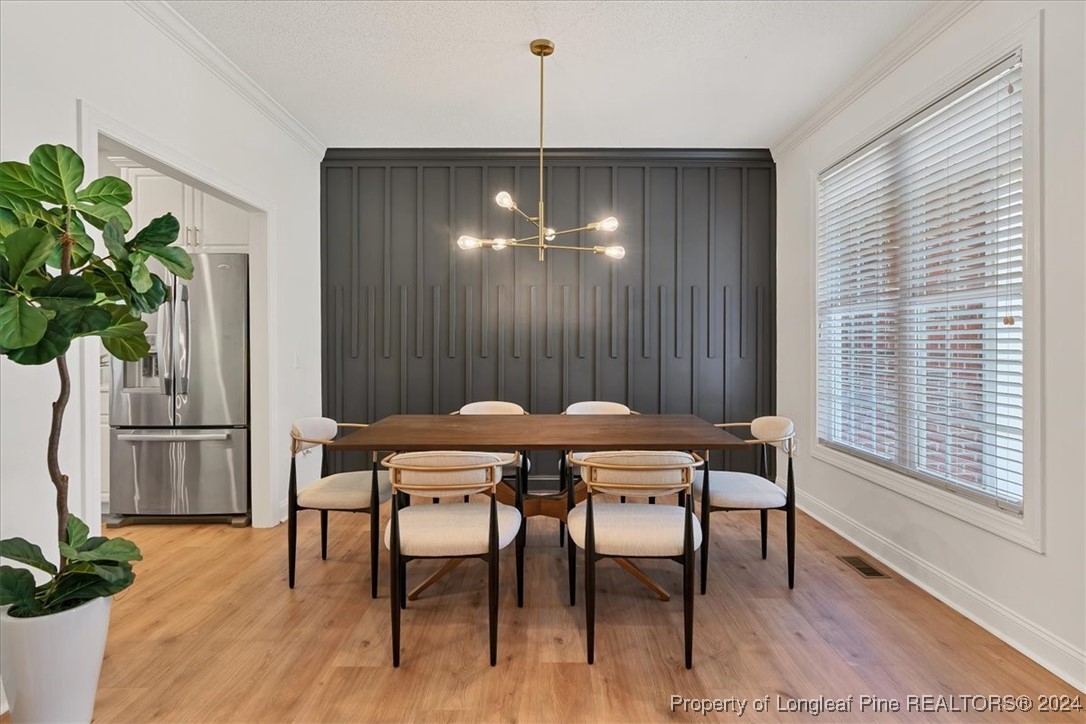 512 Maple Leaf Way Lumberton, NC 28358 - Photo 7 of 50 a dining room with furniture potted plants and wooden floor