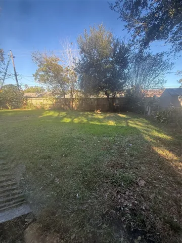 a view of a big yard with lots of green space