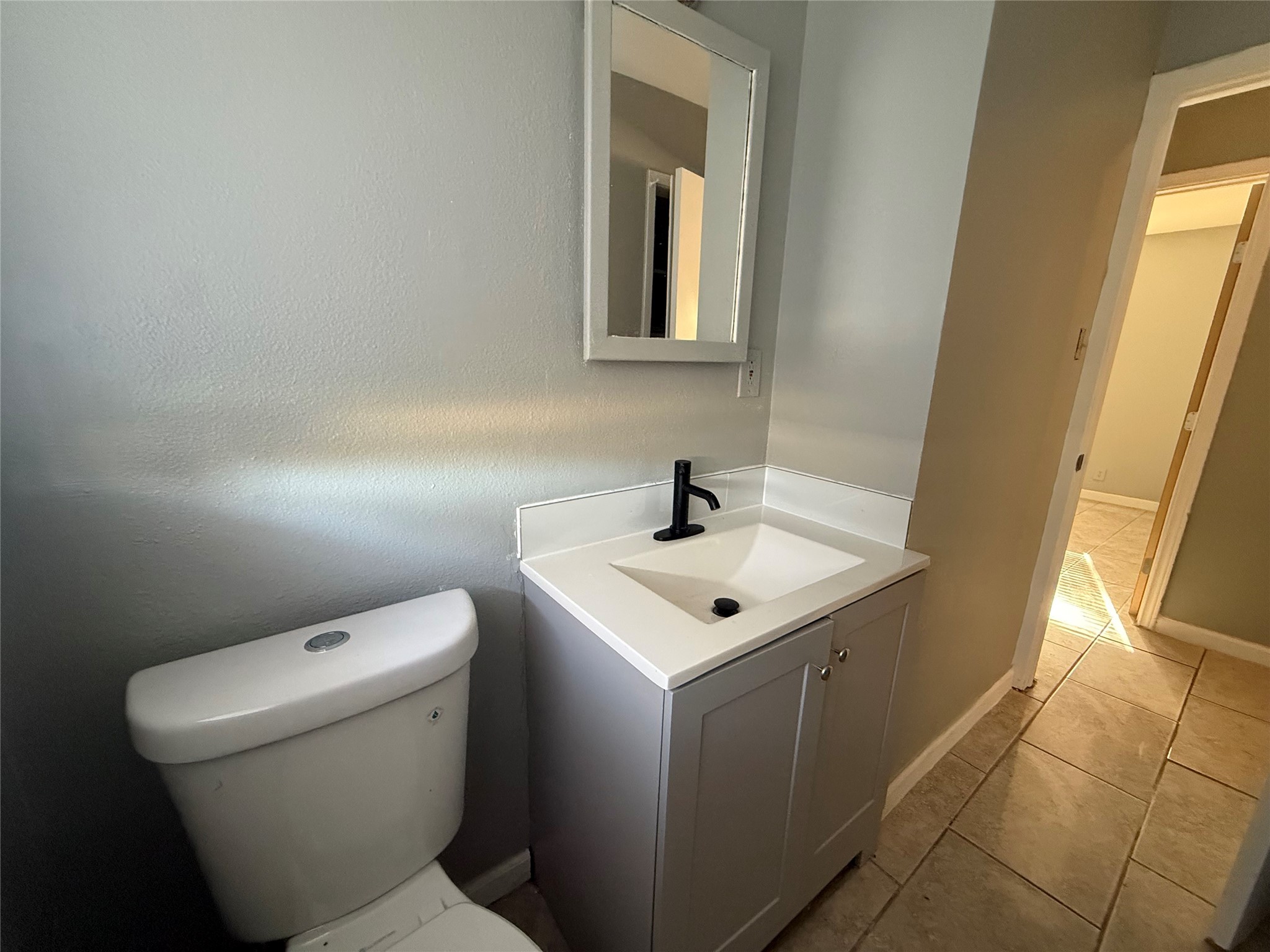 9526 Hammerly Boulevard Houston, TX 77080 - Photo 10 of 16 a bathroom with a toilet sink and mirror