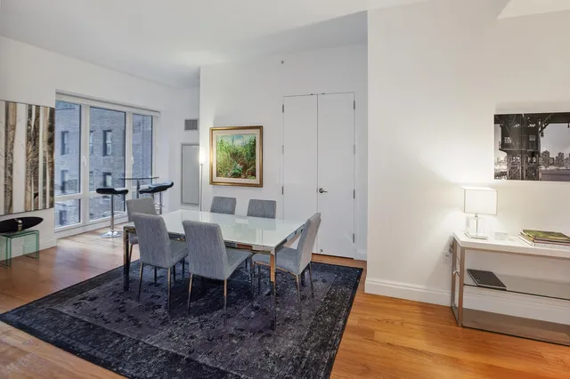a living room with furniture a rug and a window
