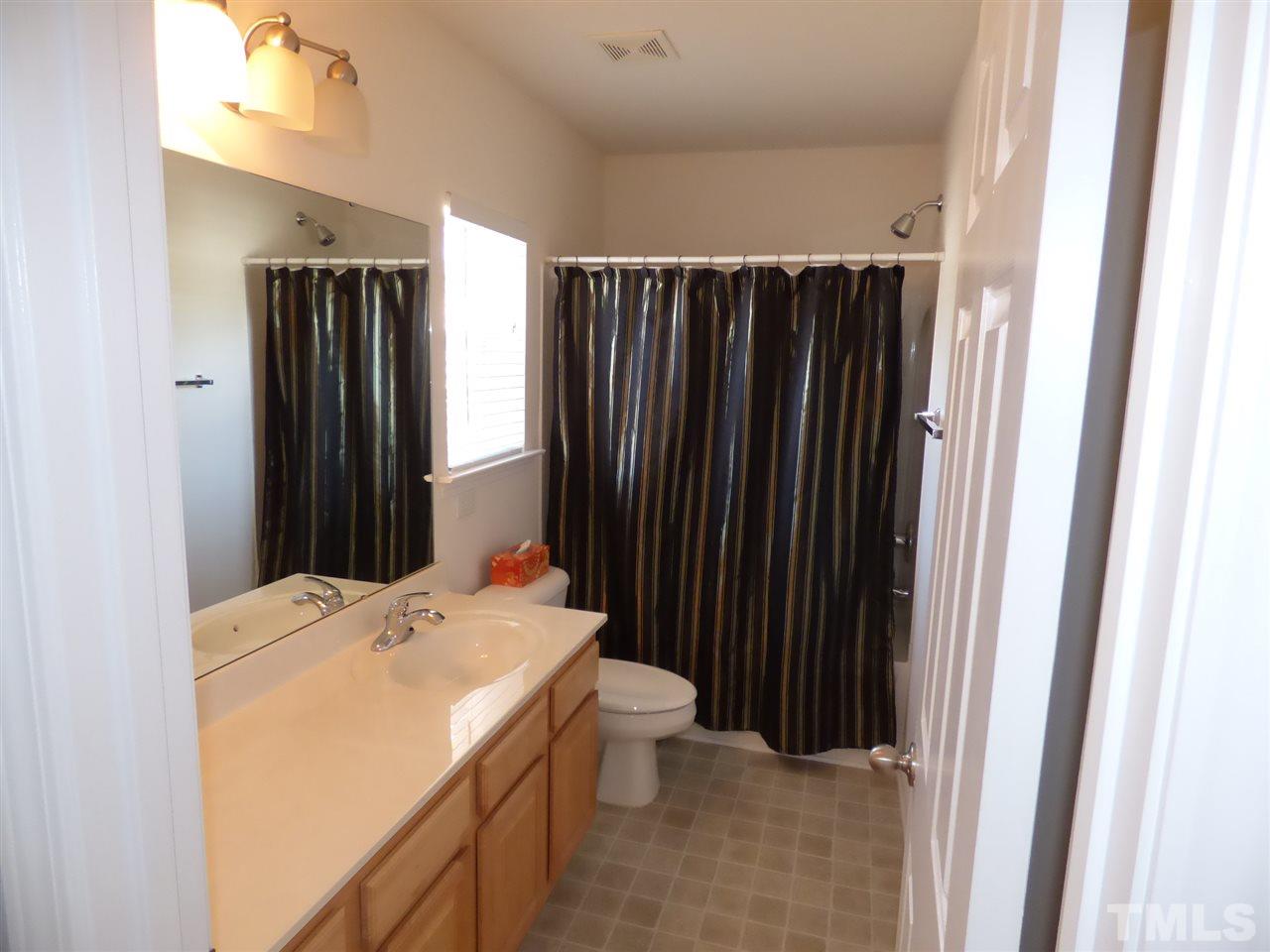 170 Ryder Cup Circle Raleigh, NC 27603 - Photo 19 of 23 a bathroom with a sink a toilet and shower