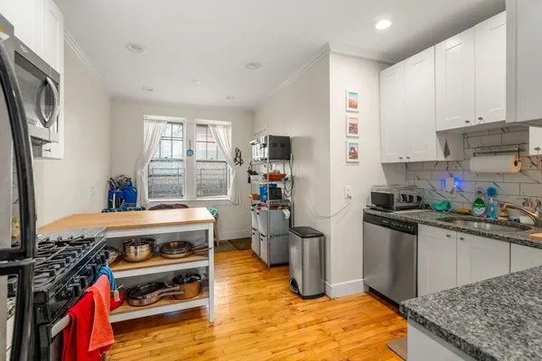 a kitchen with a stove and a refrigerator