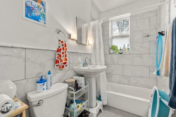 a bathroom with a sink toilet and bathtub