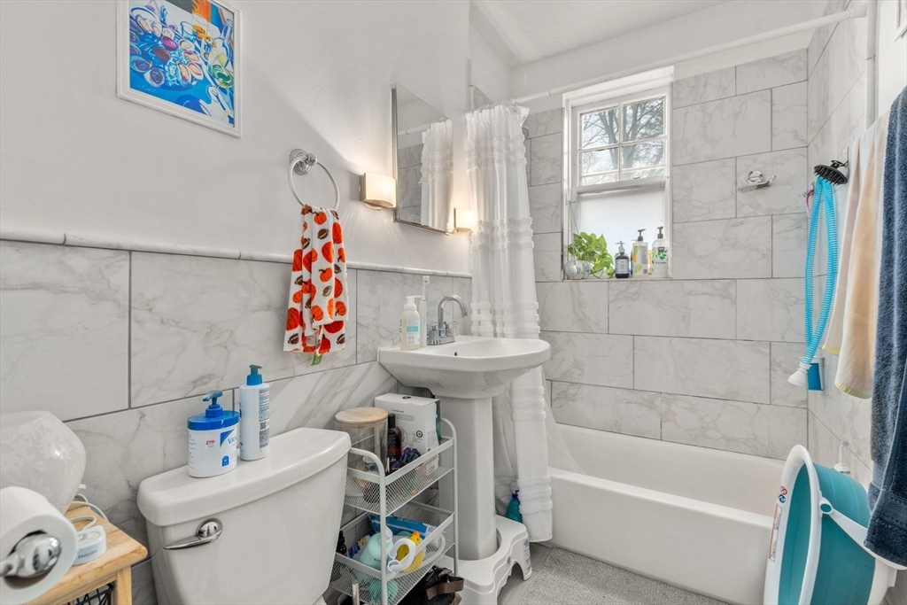 285 Corey Road, Unit 4 Boston, MA 02135 - Photo 14 of 26 a bathroom with a sink toilet and bathtub