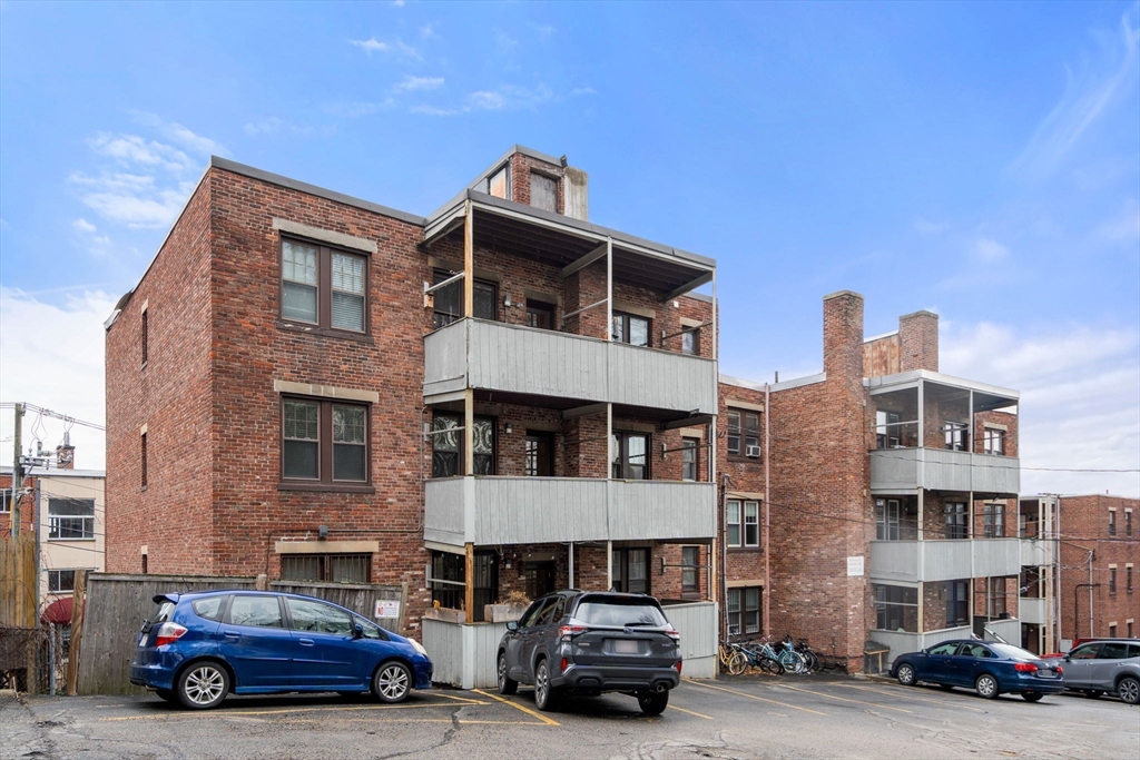 285 Corey Road, Unit 4 Boston, MA 02135 - Photo 21 of 26 a car parked in front of a building