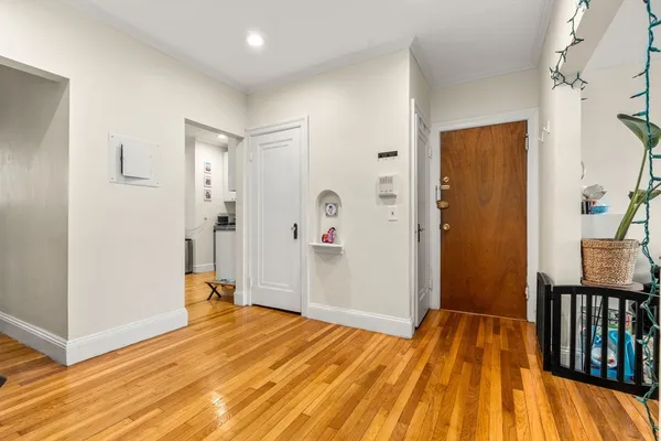 a view of hallway with wooden floor