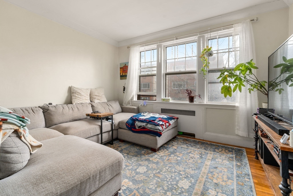 285 Corey Road, Unit 4 Boston, MA 02135 - Photo 6 of 26 a living room with furniture and a flat screen tv