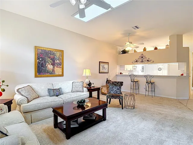 a kitchen with a dining table chairs and white appliances