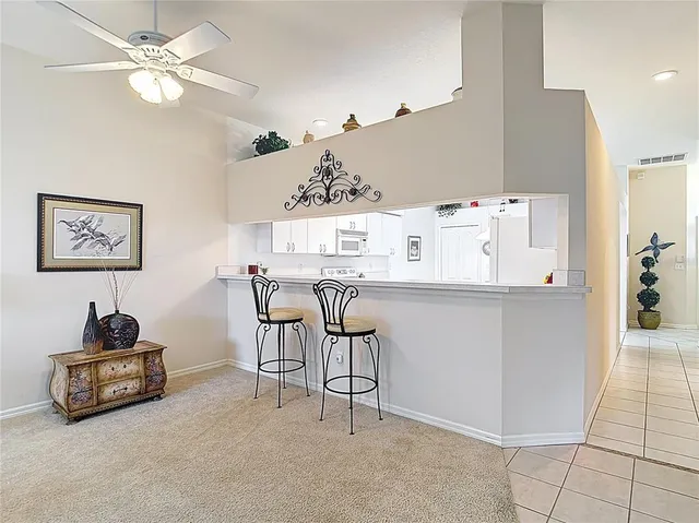 a kitchen with granite countertop white cabinets and white appliances