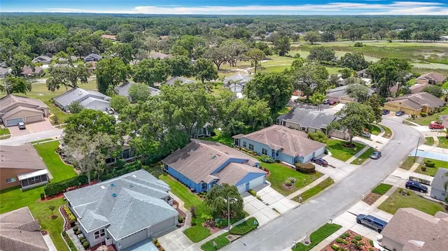 an aerial view of residential houses with outdoor space and street view