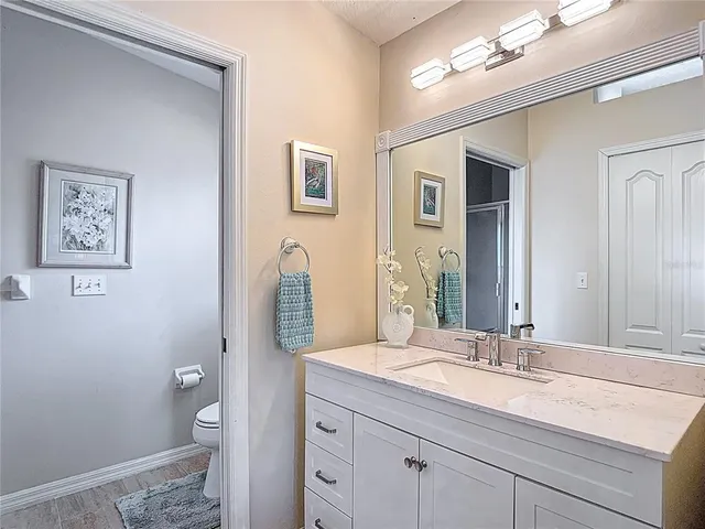 a bathroom with a sink vanity and a mirror
