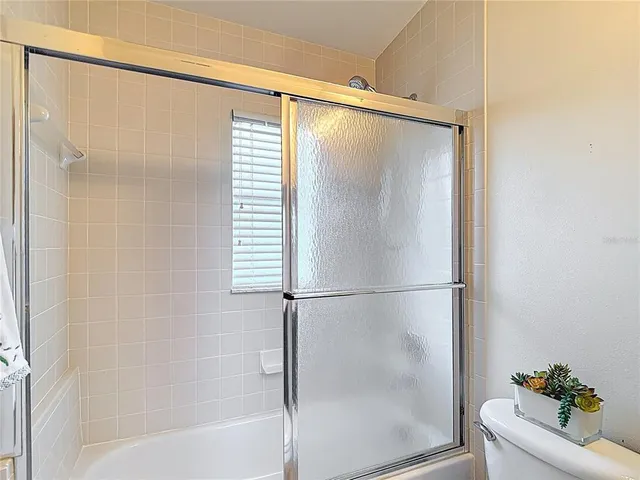 a view of house with backyard and glass windows