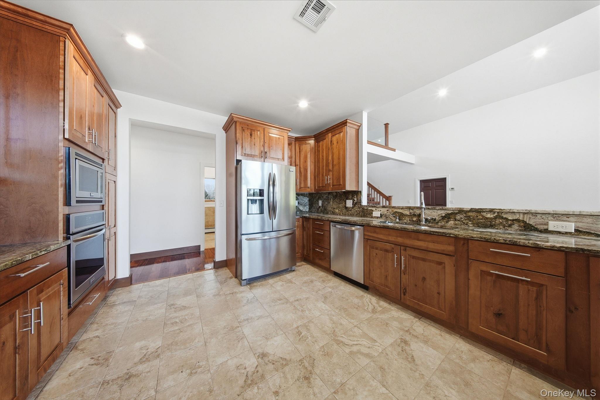 58 Deer Meadow Road White Lake, NY 12786 - Photo 14 of 50 a kitchen with stainless steel appliances granite countertop a refrigerator a sink and a stove