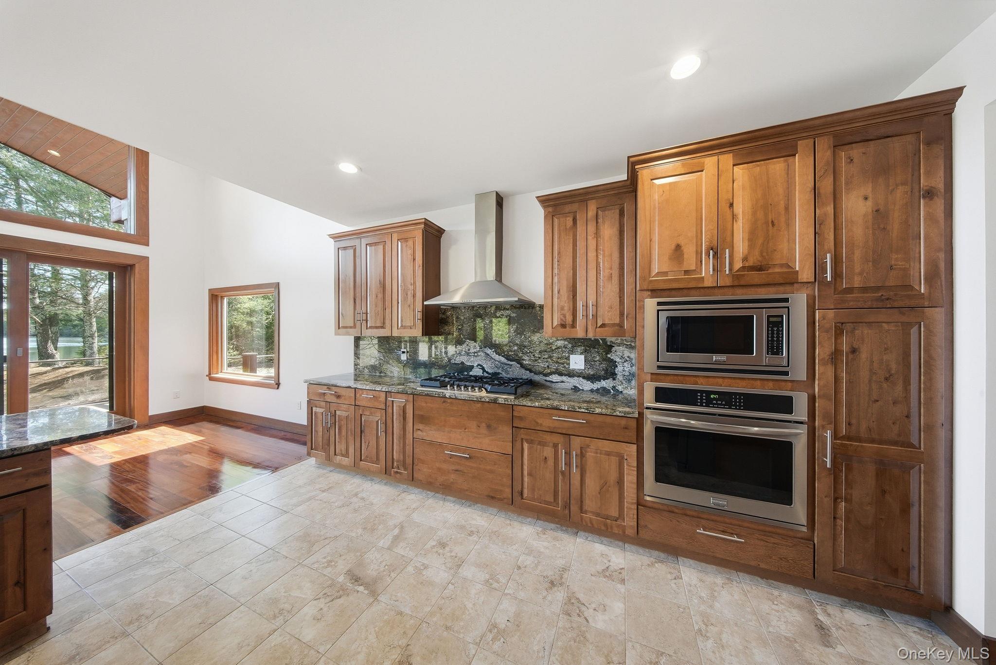 58 Deer Meadow Road White Lake, NY 12786 - Photo 19 of 50 a kitchen with stainless steel appliances granite countertop a stove top oven microwave and cabinets