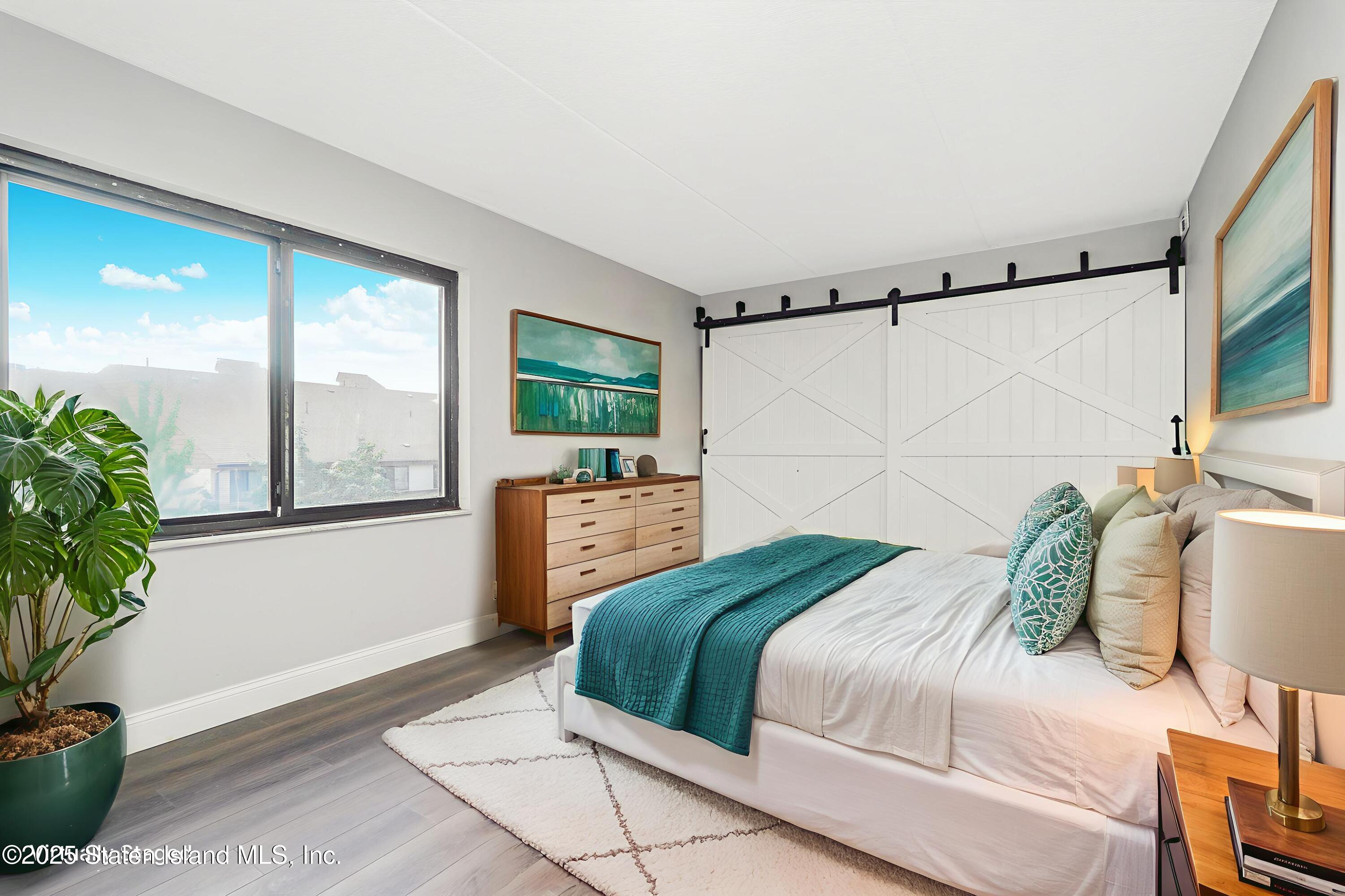 11 Windham Loop, Unit 3II Staten Island, NY 10314 - Photo 6 of 18 a bedroom with a bed window and potted plant