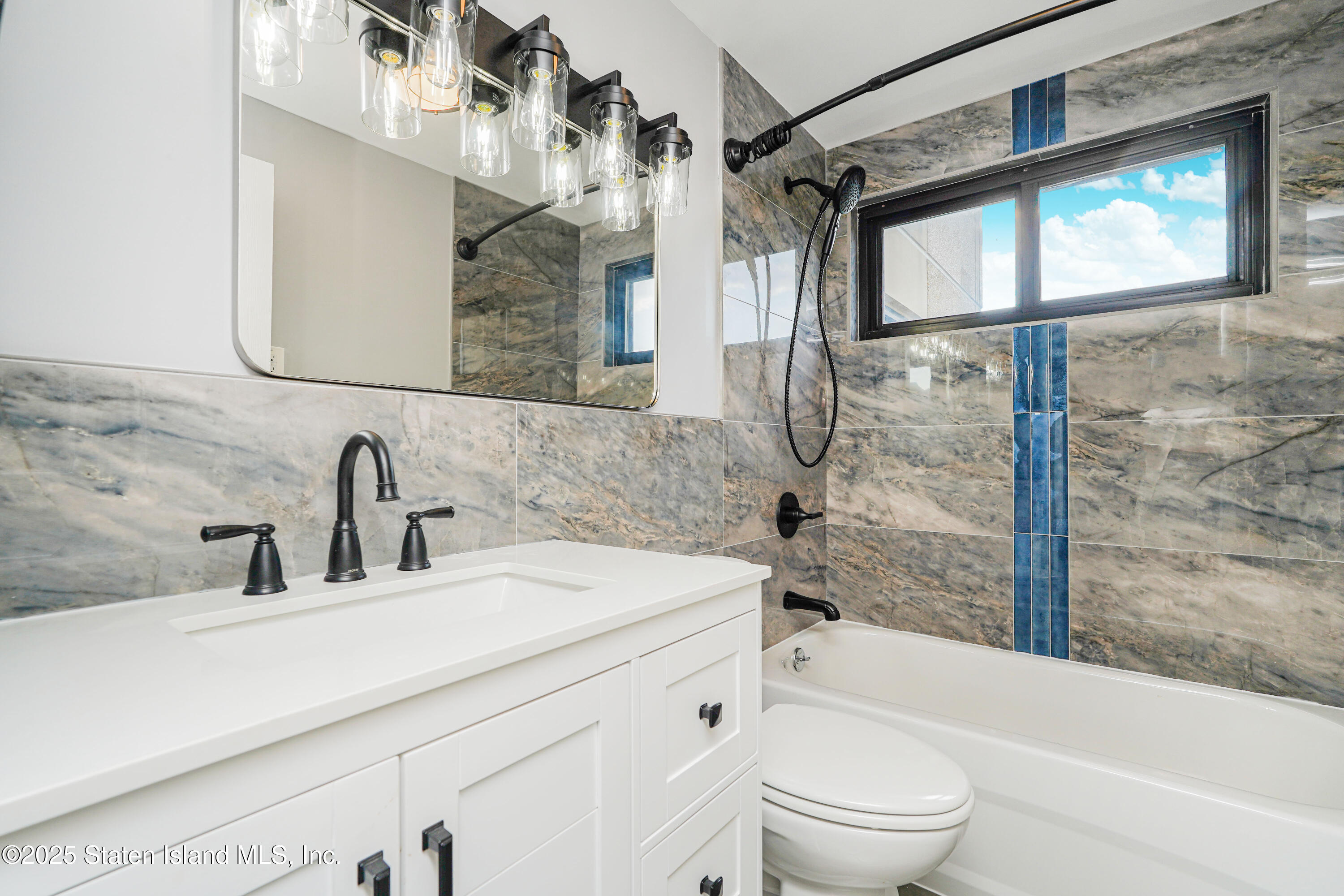 11 Windham Loop, Unit 3II Staten Island, NY 10314 - Photo 9 of 18 a bathroom with a sink a toilet and shower
