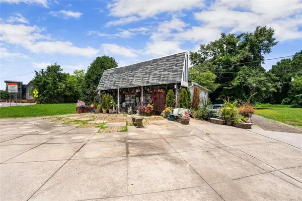 a view of a house with entertaining space and a garden