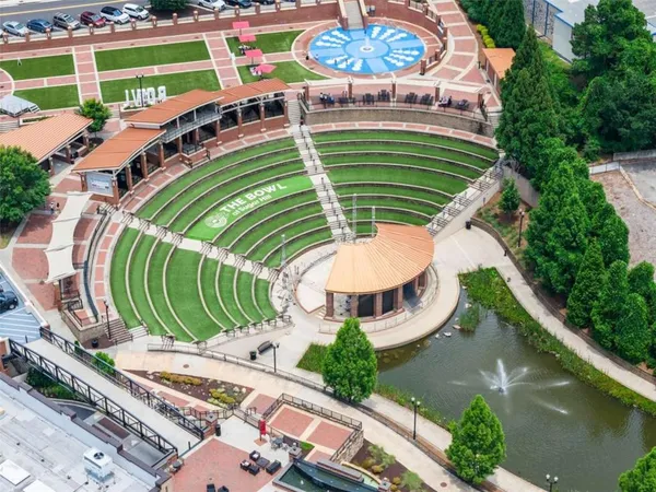 a view of a wooden floor with a big yard and potted plants